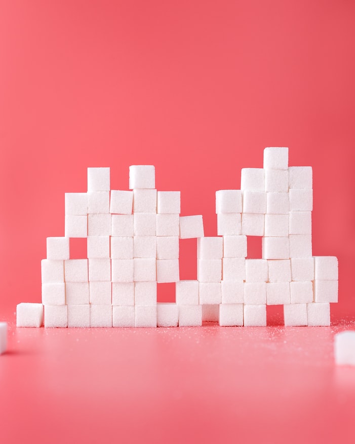 cubes of sugar in pink background