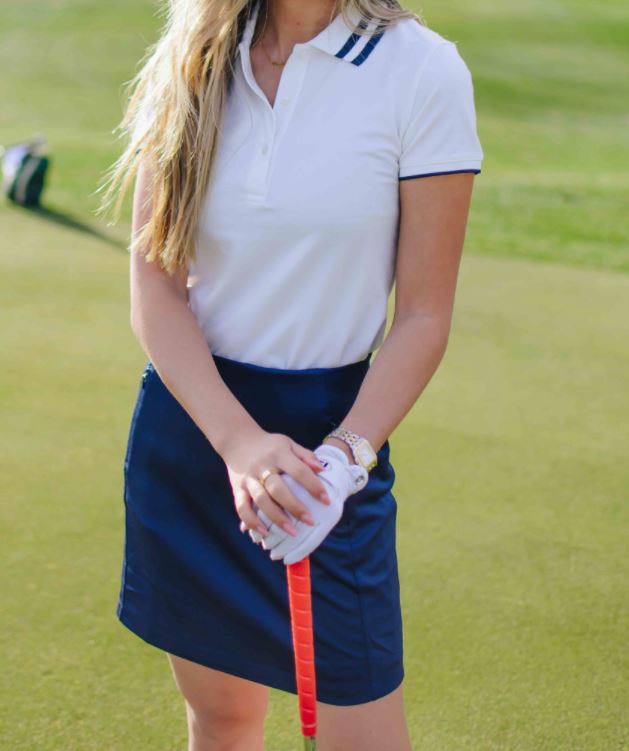women's golf outfit with a white collared shirt and a skirt
