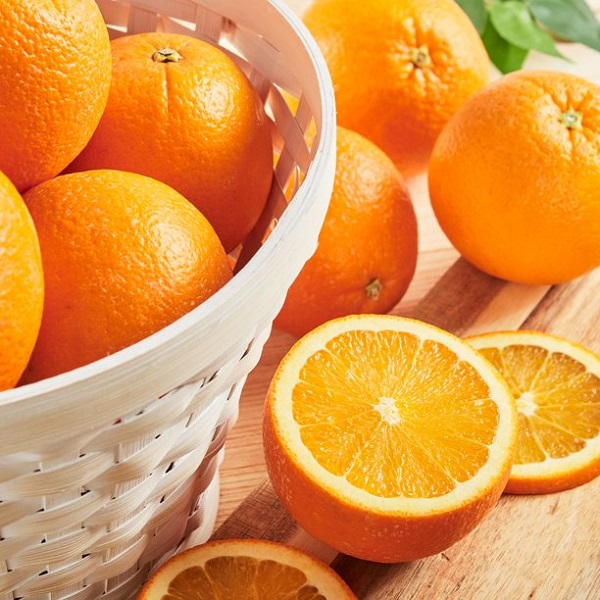 oranges in a white basket as a low calorie fruit